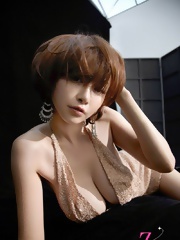 Anri Sugihara posing her super big breasts in a satin dress