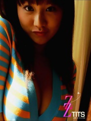 Ayami Sakurai posing big breasts in colored suite