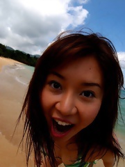 Big breasted Yui Seto posing at the beach in a small bikini