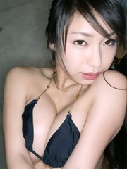 Oda Arisa posing in dark suit her amazing boobs